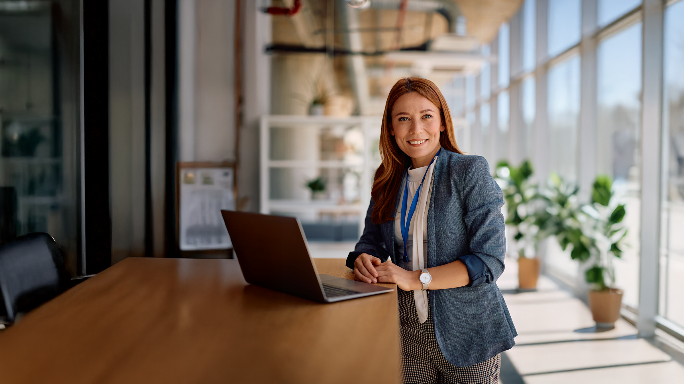 Sickness Absence Administrator working at a desk with a laptop
